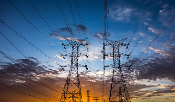 Image of a electricity pylons with sunset behind