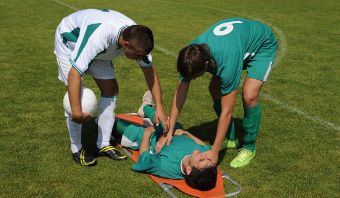 footballer injured laying on floor