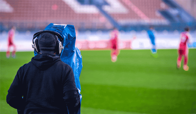 TV camera filming a football match