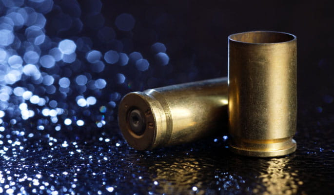 Close up image of two bullet shells on the ground