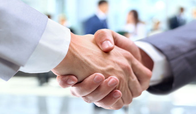 A image of two people shaking hands