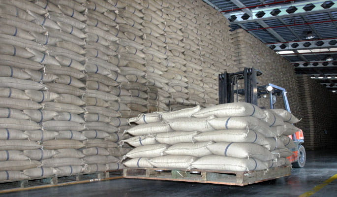 A image of raw materials piled high in a warehouse 
