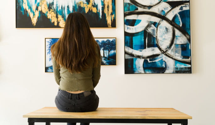 woman sitting in art gallery banner teaser
