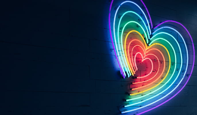 Image of a heart shaped neon light in rainbow colours