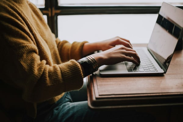 woman typing on laptop